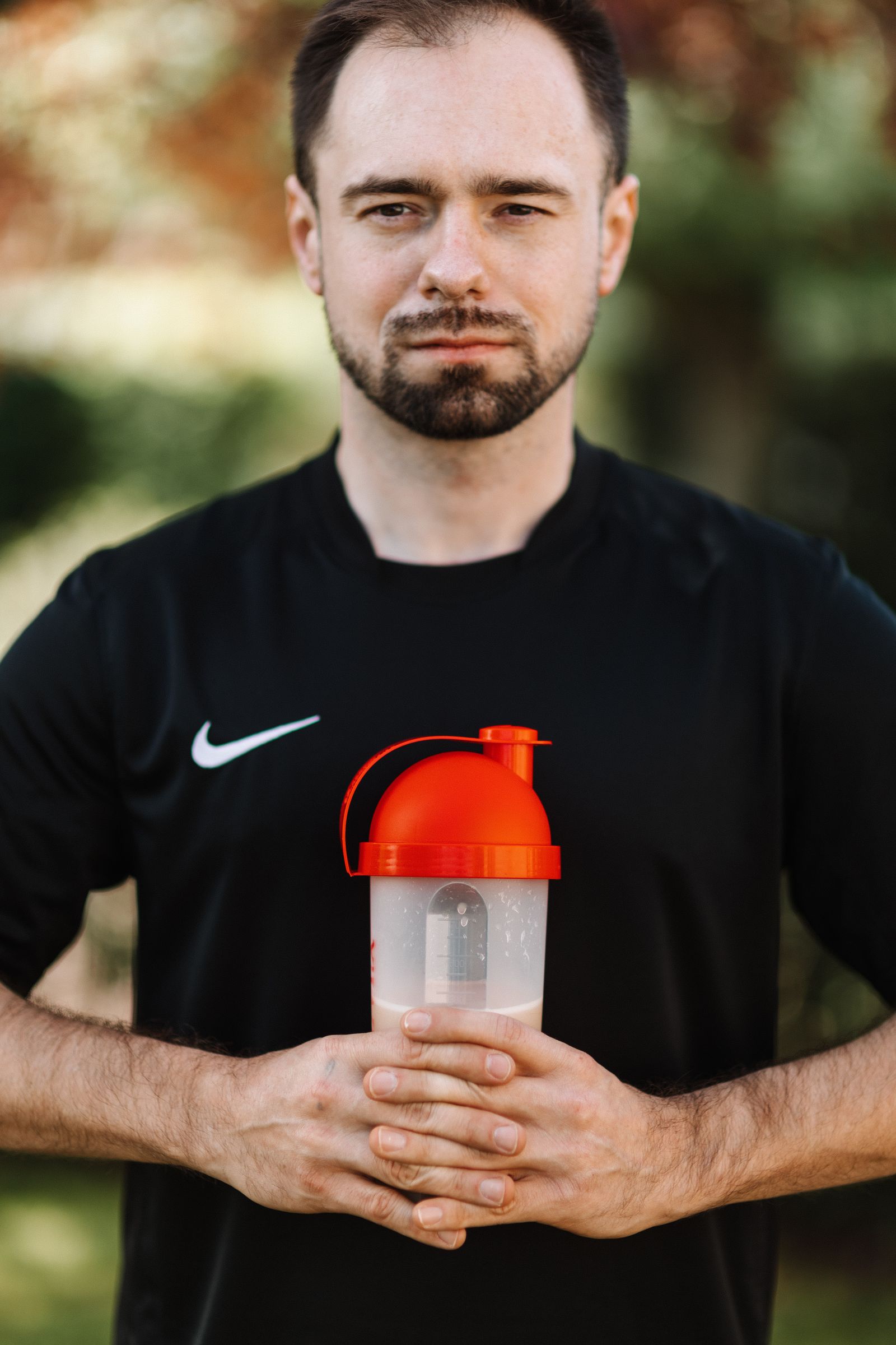 Fitness enthusiast holding a protein shaker bottle